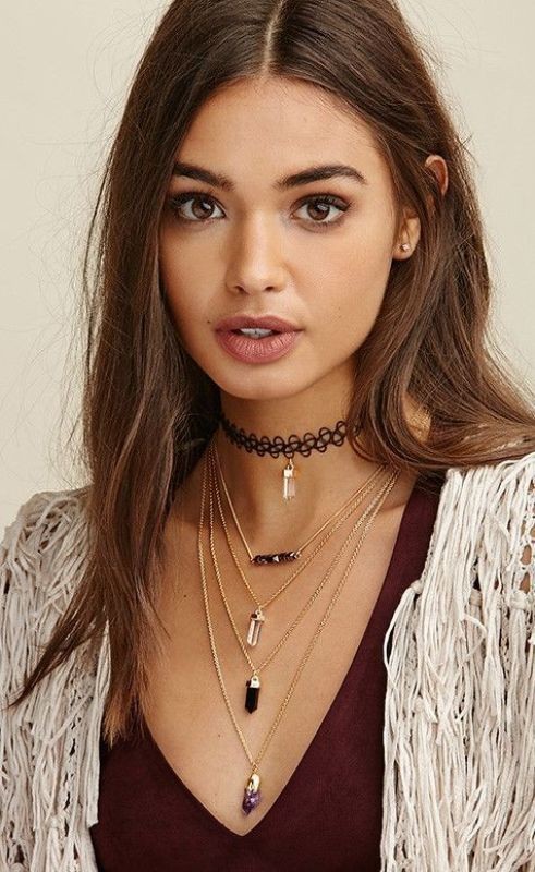 Trendy woman wearing multilayred necklackes