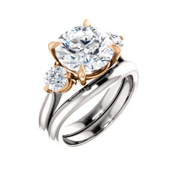 white and rose gold engagement ring with large center diamond and diamond on either side