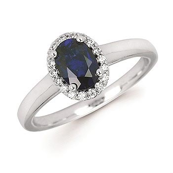 white gold enegagement ring with sapphire in the center and a halo of diamonds 